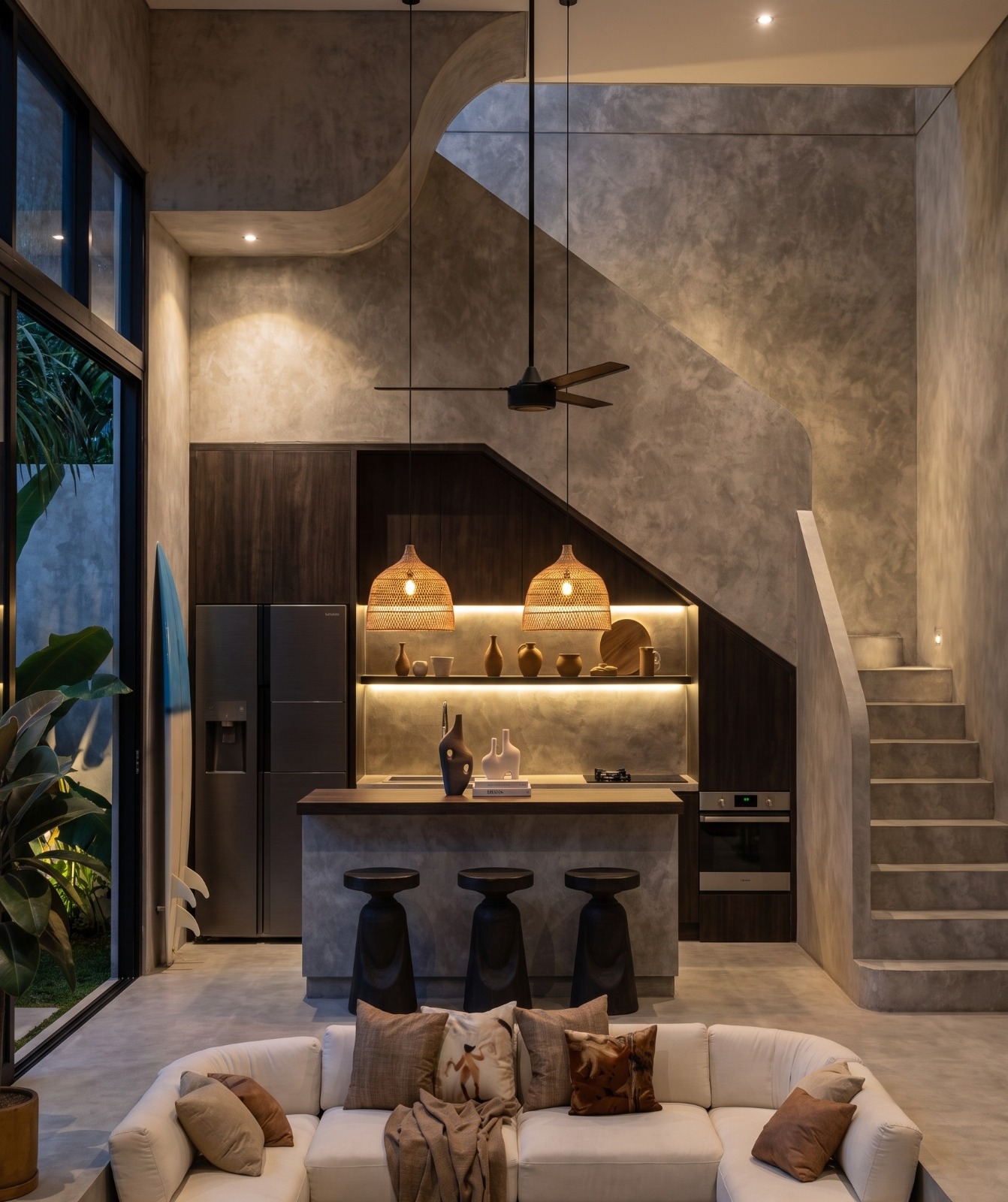 Kitchen tucked under the sculptural concrete staircase