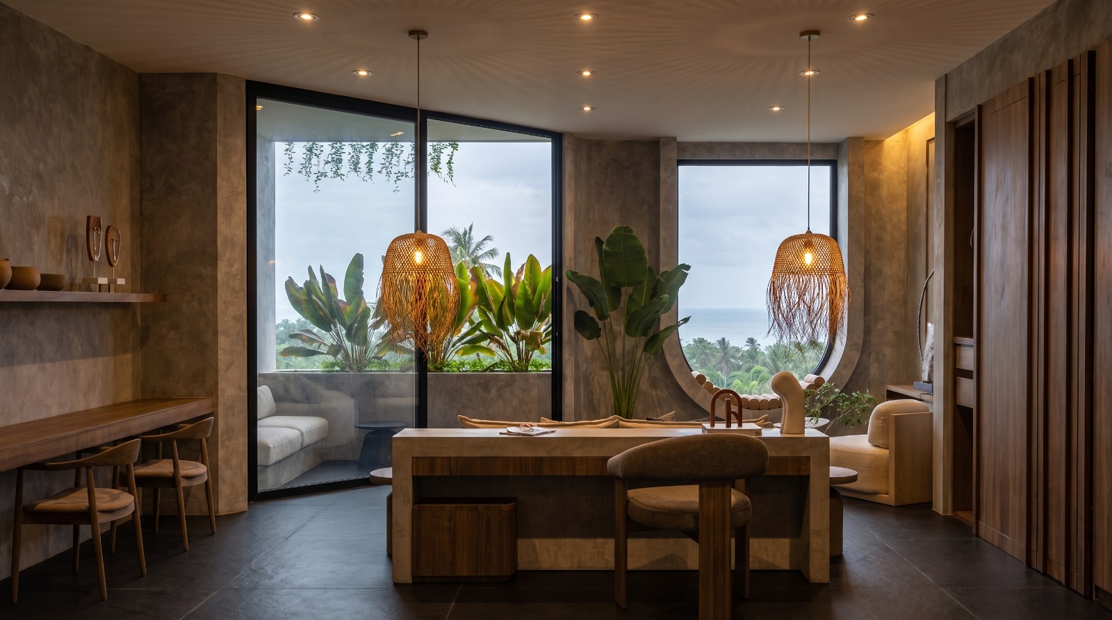 Master suite sitting area with rattan pendants and ocean view