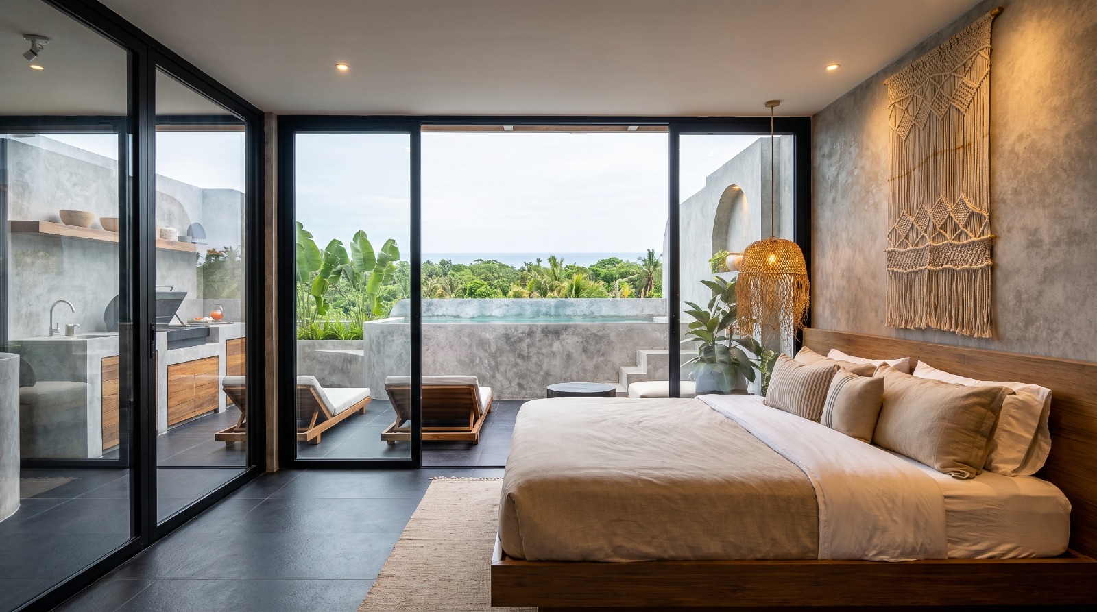 Rooftop bedroom opening onto the private pool, outdoor kitchen and ocean horizon